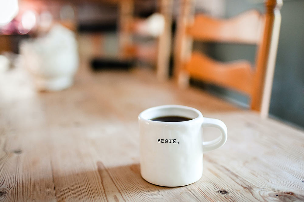Photo of the coffee mug with 'Begin' written across by Danielle MacInnes